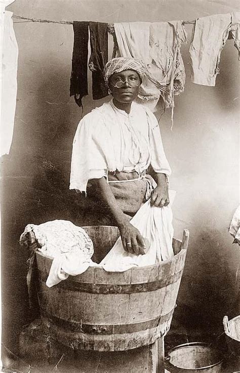 fake painting of black woman washing clothes in barrel